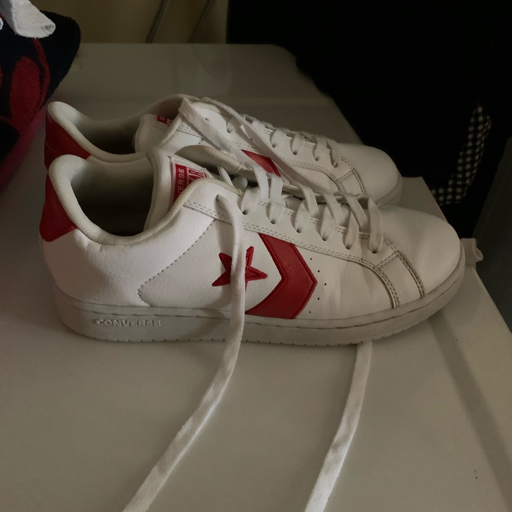 White converse sneakers with red accents
